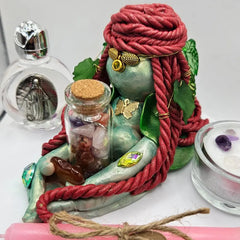 Close-up of Aisling Goddess Brigid figurine with carnelian, crystal vial and handmade decorative details