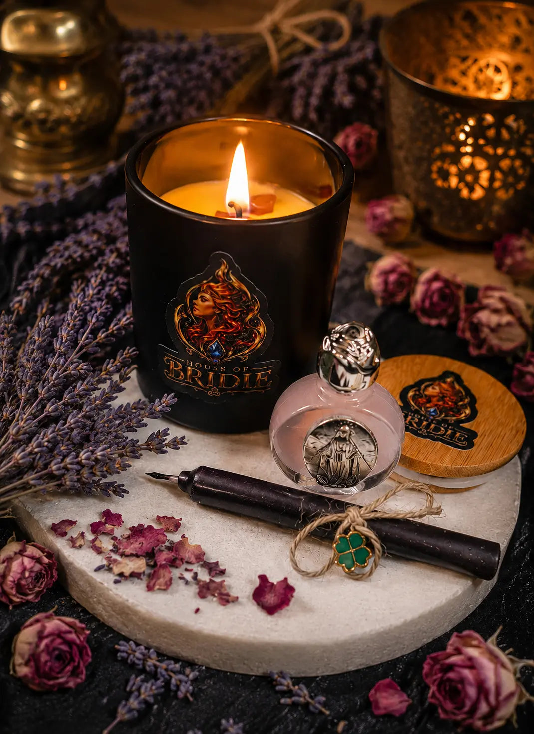 Brigid's Rose Ritual Candle with Rose and Lavender beside a Brigid altar
